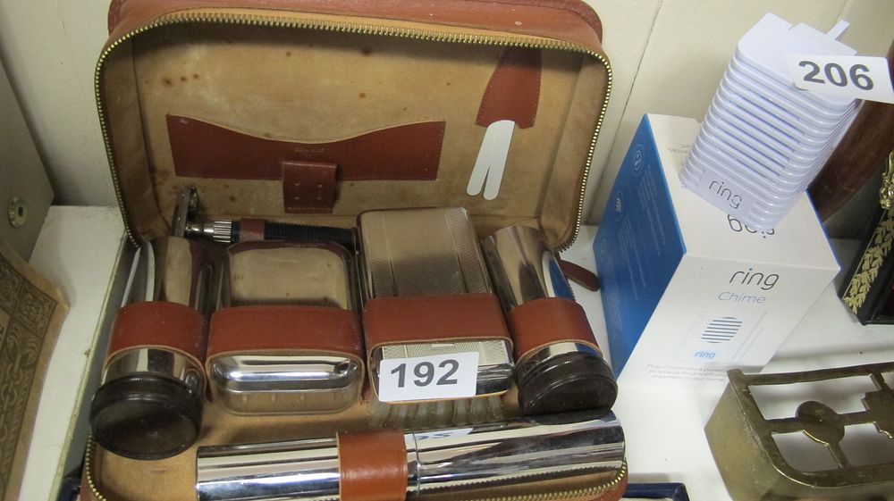 Lot 192: A Vintage Leather Gentleman's Travel Grooming Set and a Ring Chime Second Generation