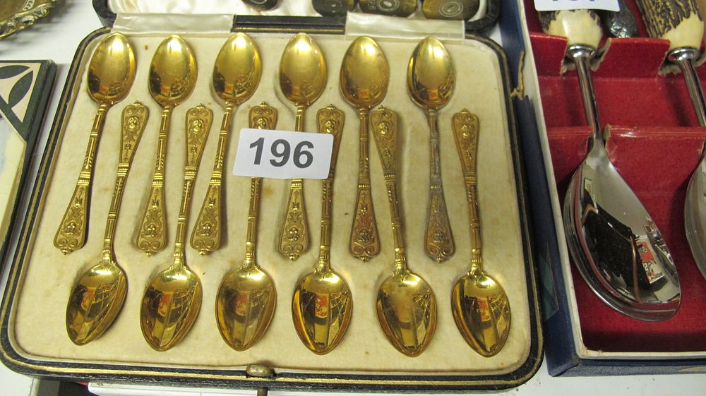 Lot 196: A Cased Set of Twelve Victorian Style Gilt Metal Teaspoons