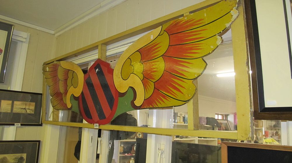 Lot 296: Large Painted Wooden Fairground Decorative Fascia with Winged Shield