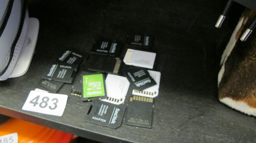 Lot 483: An Assortment of SD Card Adapters and Memory Cards Including SanDisk