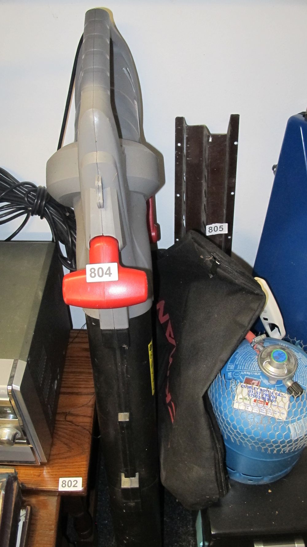Lot 804: An Electric Garden Blower Vacuum with Collection Bag and Gas Bottle