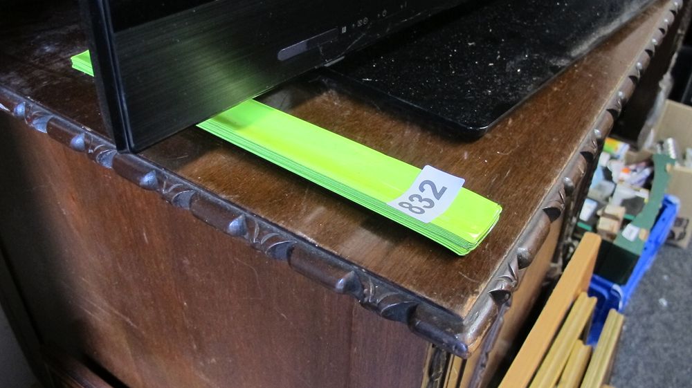 Lot 832: A Modern Flat Panel Television and a Collection of Reflective Slap Bands