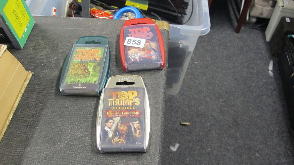 Lot 858: A Trio of Winning Moves Top Trumps Card Games Featuring Lord of the Rings, WWE, and Pirates of the Caribbean