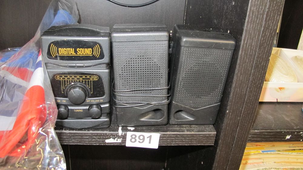 Lot 891: A Trio of Portable Electronics Comprising an AM/FM Radio and Two Matching Speakers