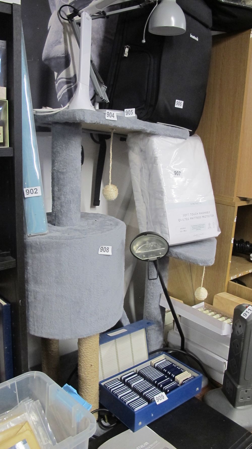 Lot 908: An Assortment of Household Items Including a Cat Tree, Mattress Protector, and Desk Lamp