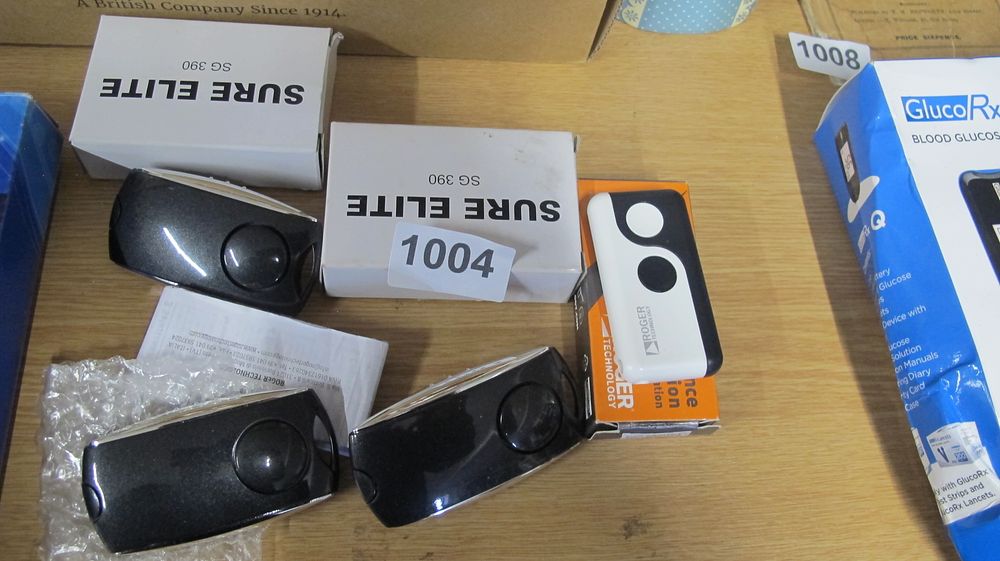 Lot 1004: A Collection of Roger Technology and Sure Elite Garage Door Remote Controls and Accessories