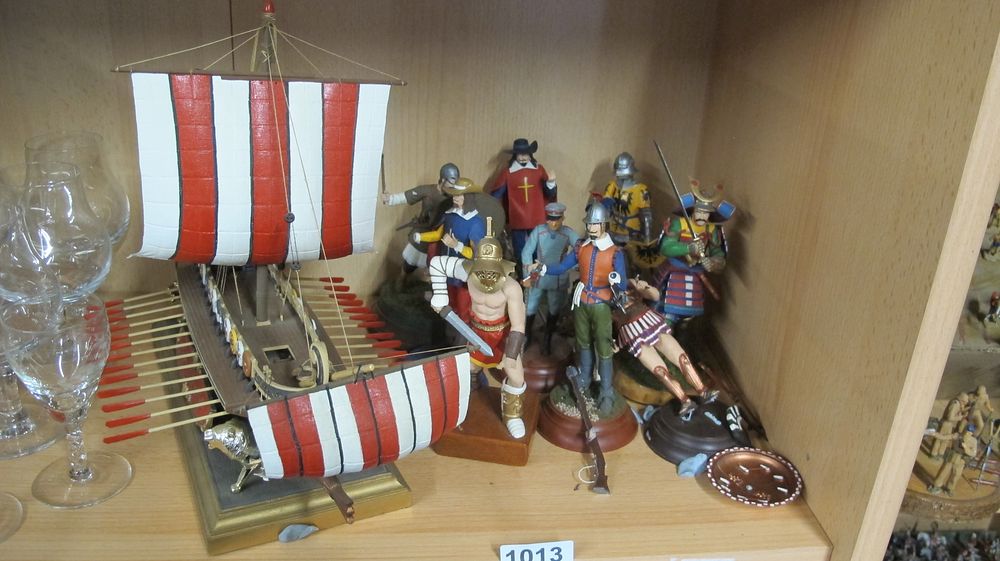 Lot 1013: A Collection of Historical Military Figurines and a Scale Model Ancient Galley