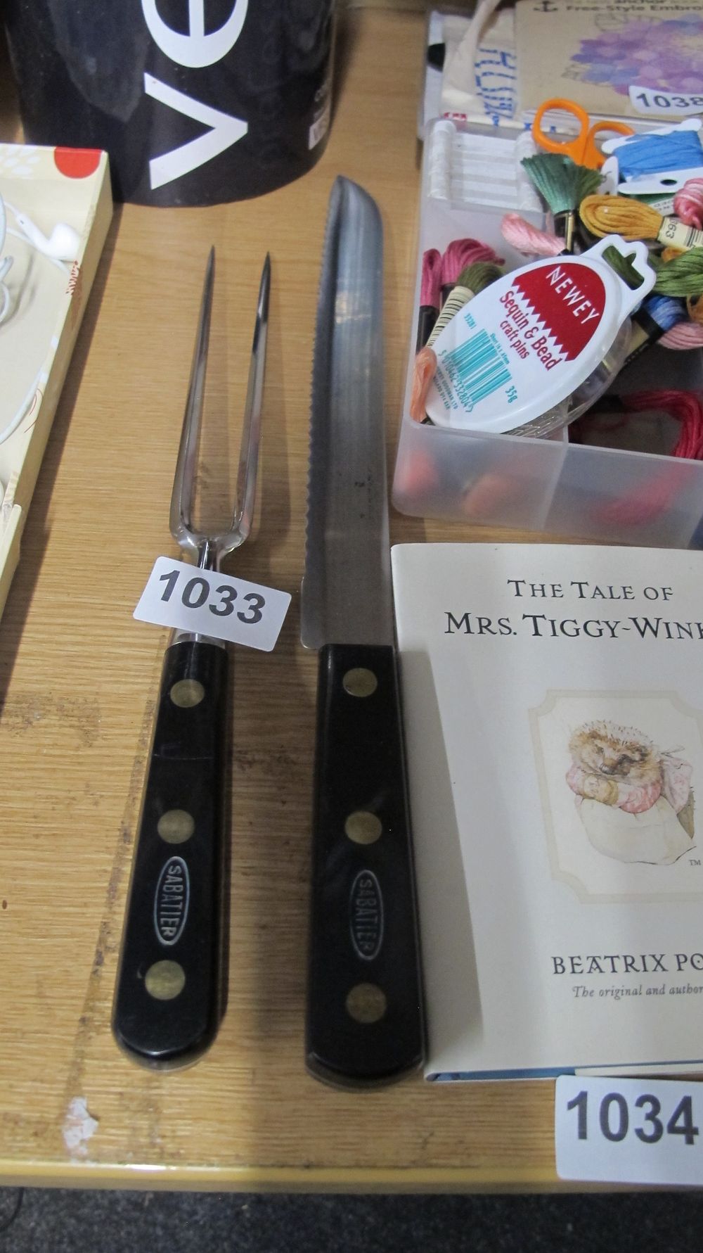 Lot 1033: A Pair of Sabatier Stainless Steel Serrated Carving Knife and Meat Fork