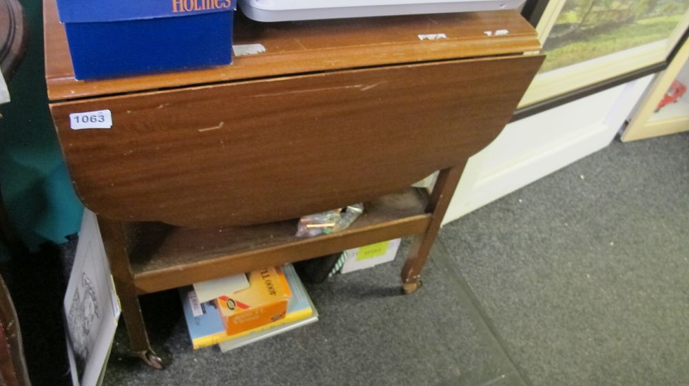 Lot 1063: Mid-century wood veneer drop-leaf tea trolley