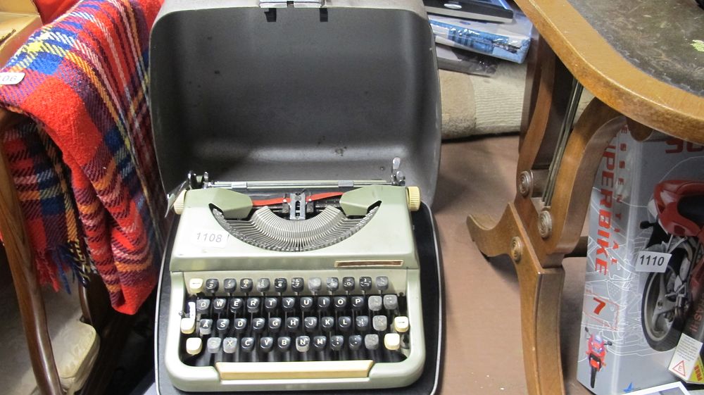 Lot 1108: Vintage Portable Manual Typewriter in Original Grey Hard Shell Case