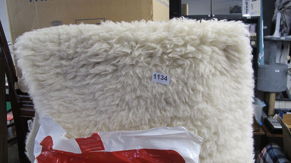 Lot 1134: A Rectangular Off-White Sheepskin Style Rug