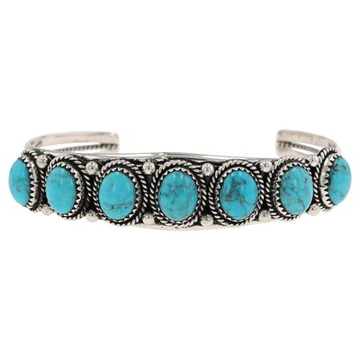A Navajo Sterling Silver and Kingman Turquoise Cuff Bracelet by Verley Betone. A sterling silver 