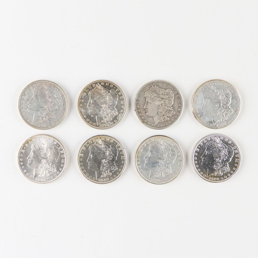 8 Morgan Silver Dollars. Group of eight Morgan silver dollar coins including: one 1899, one 