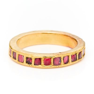 Gold & Ruby Ring. 18k yellow gold band set with 23 rubies in square setting. Unmarked, tested 