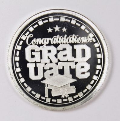 2024 1OZ GRADUATION SILVER ROUND. .999 PURE SILVER. ESTIMATE: $50-$75