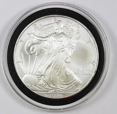 2009 AMERICAN SILVER EAGLE. SUPERB GEM BU. IN PLASTIC CAPSULE. ESTIMATE: $50-$75