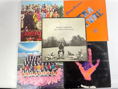 Lot 5 vinyl records by George Harrison and The Beatles A collection of vinyl records featuring 
