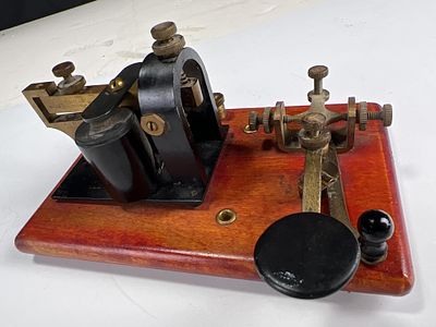 E.F. Johnson Telegraph key and sounder on dramatic stained wood base, wiring instructions on 
