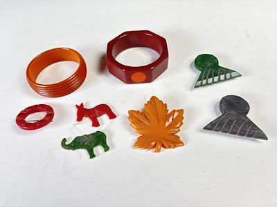Lot of vintage Bakelite accessories/pieces. Red and butterscotch bangle, one with orange inlays 