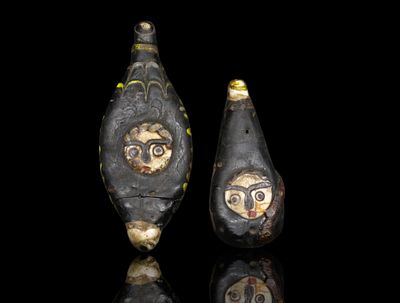 Ancient Phoenician Glass pendants. This artifact is an ancient Phoenician glass pendant shaped 