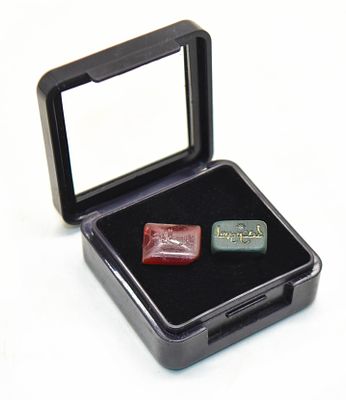 Two Islamic intaglios or signet seals, featuring intricate Arabic calligraphy inscriptions. Thes 