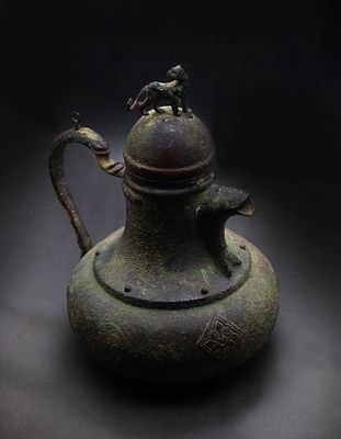 Persian Seljuk copper-inlaid bronze Ewer, Eastern. It features a distinctive green and dark 