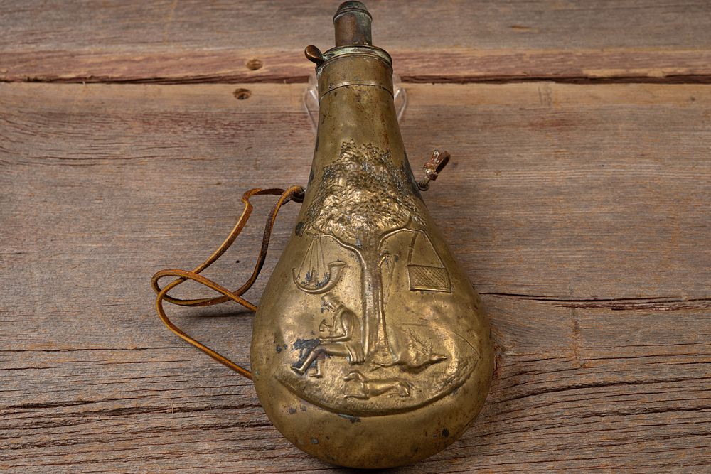 Lot 201: Embossed Brass Hunting Motif Powder Flask