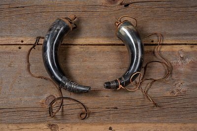Pair of Black Powder Horns with Leather Straps. C-20775 Pair of curved black powder horns formed 
