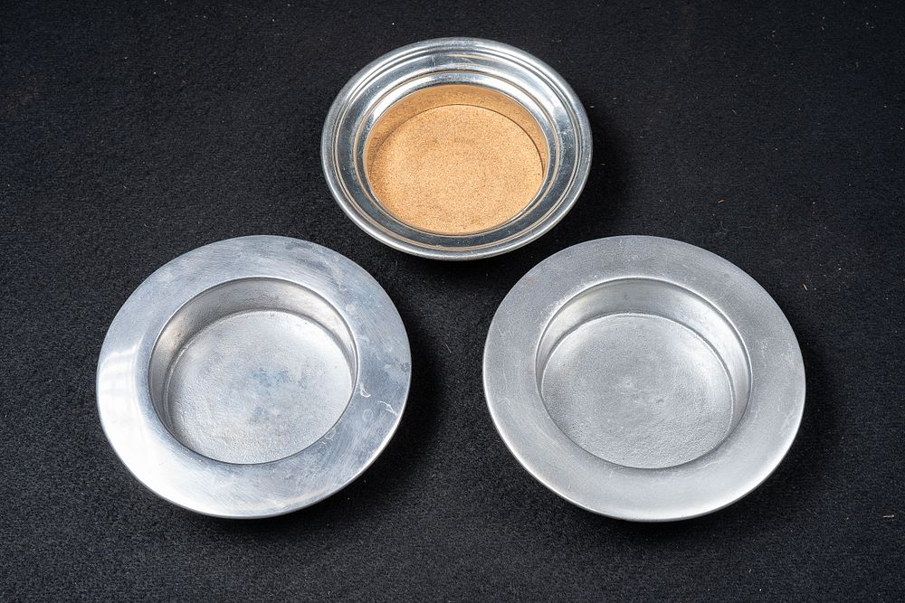 Lot 69: Three Pewter Wine Bottle Coasters