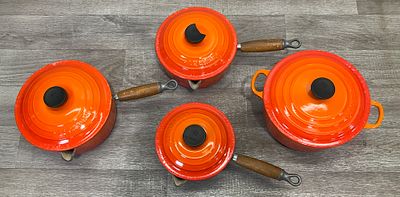 * A Set of Vintage Le Creuset Volcanic Orange Enamelled Cast Iron Cookware. A set of vintage 