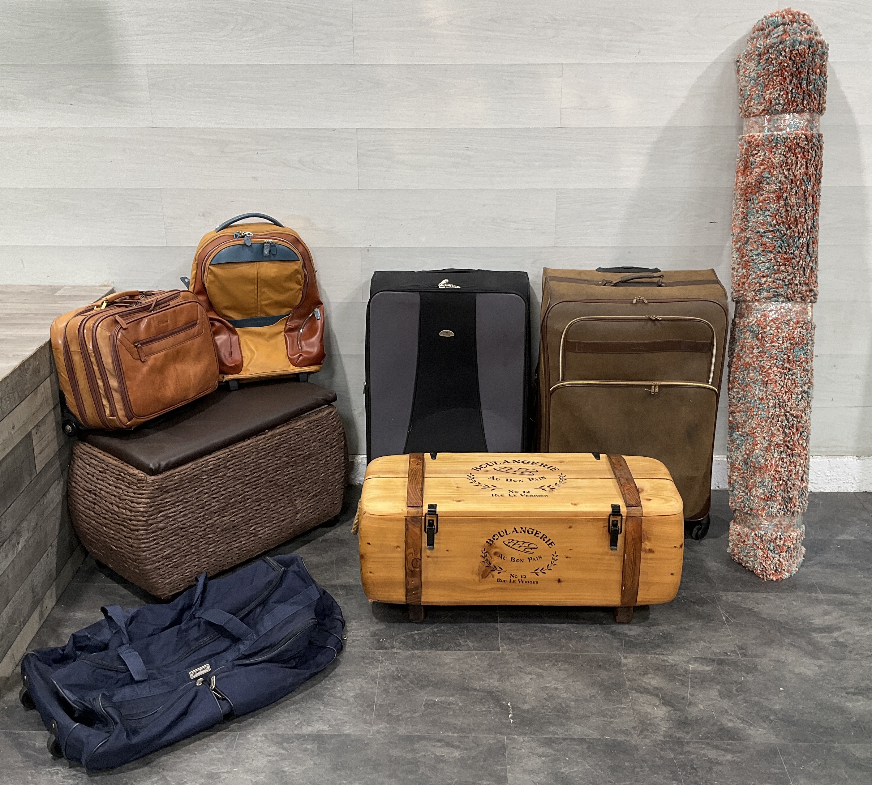 * An Assortment of Travel Luggage, Storage Furniture, and a Rolled Shag Rug