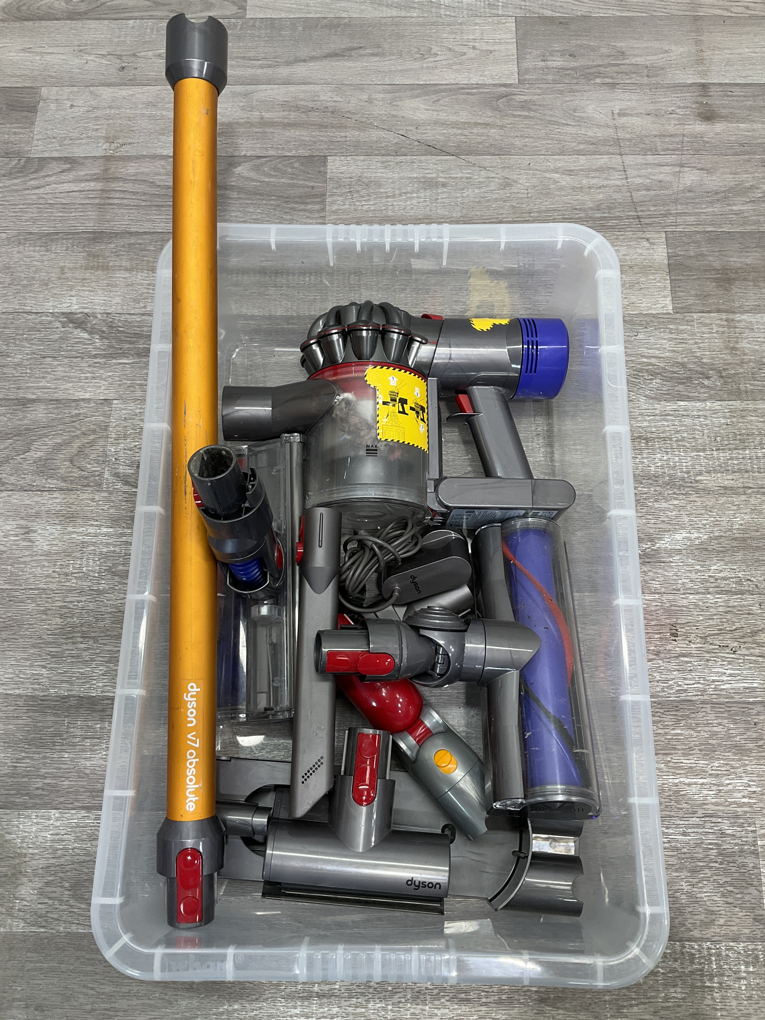 * A crate containing a Dyson V7 Absolute cordless vacuum cleaner and accessories