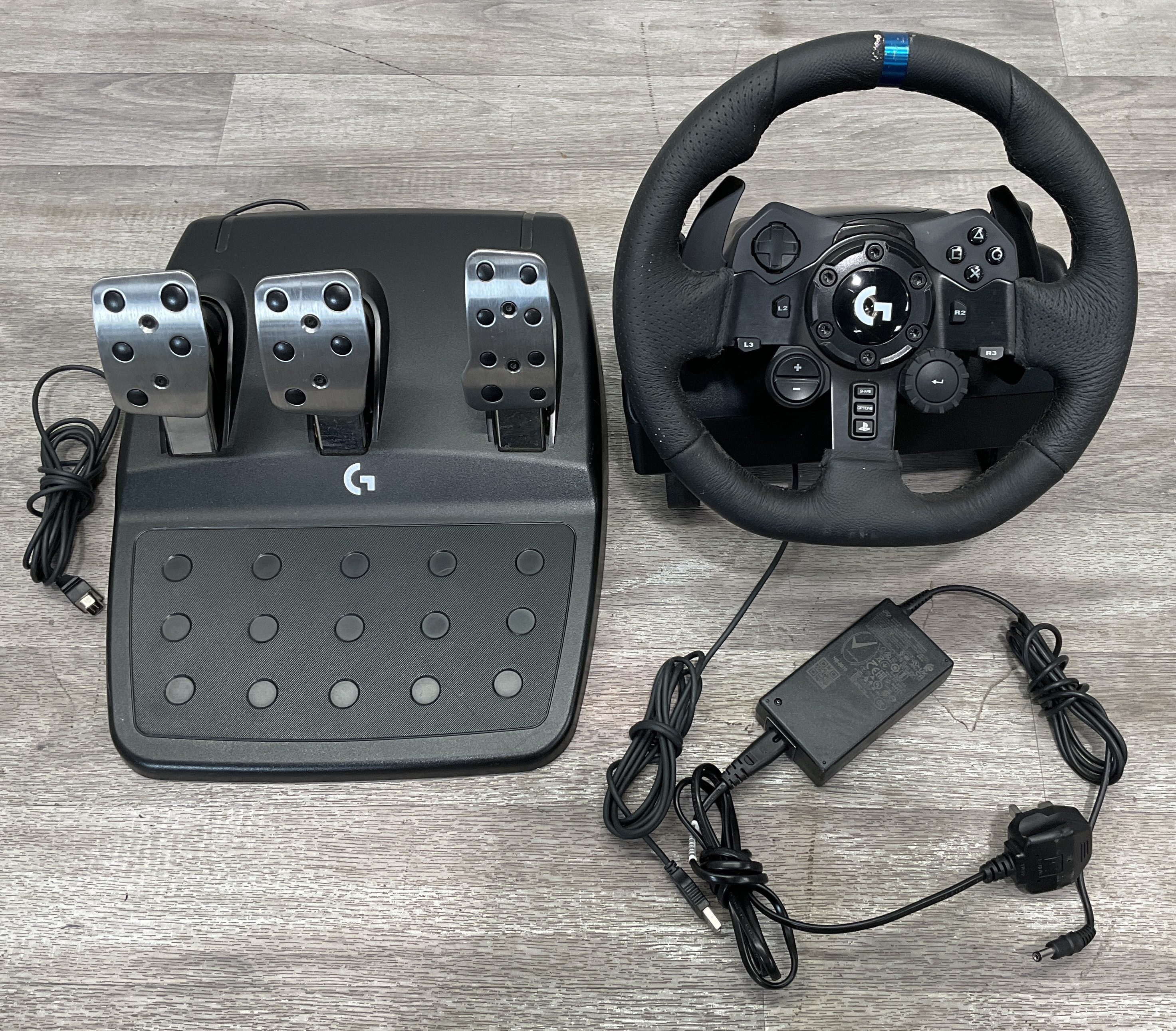 * A carton containing a Logitech G923 Racing Wheel and Pedals for PlayStation and PC