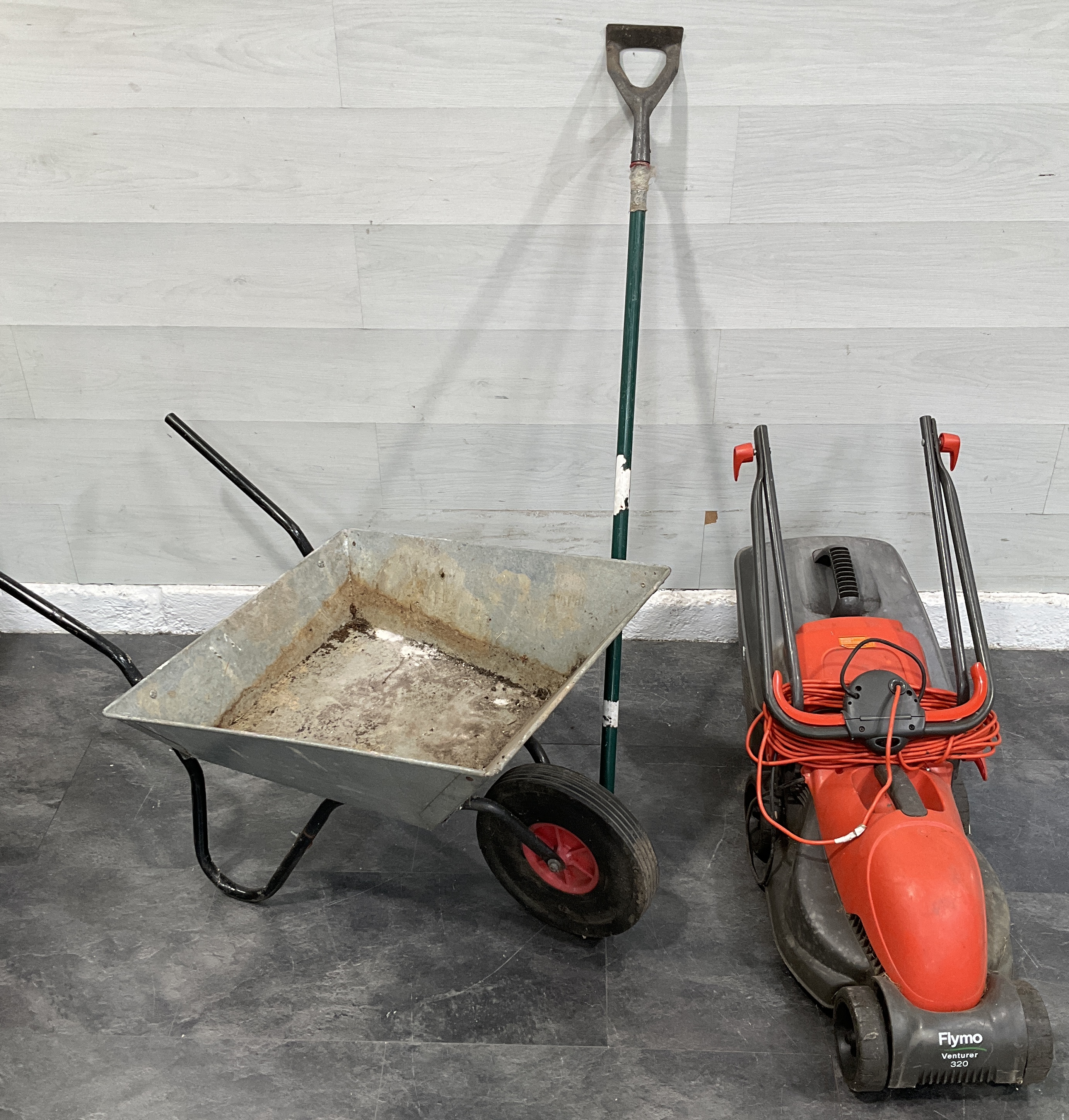 * A Trio of Garden Equipment Including a Flymo Venturer 320 Lawnmower, Galvanised Wheelbarrow, and Long-handled Dutch Hoe