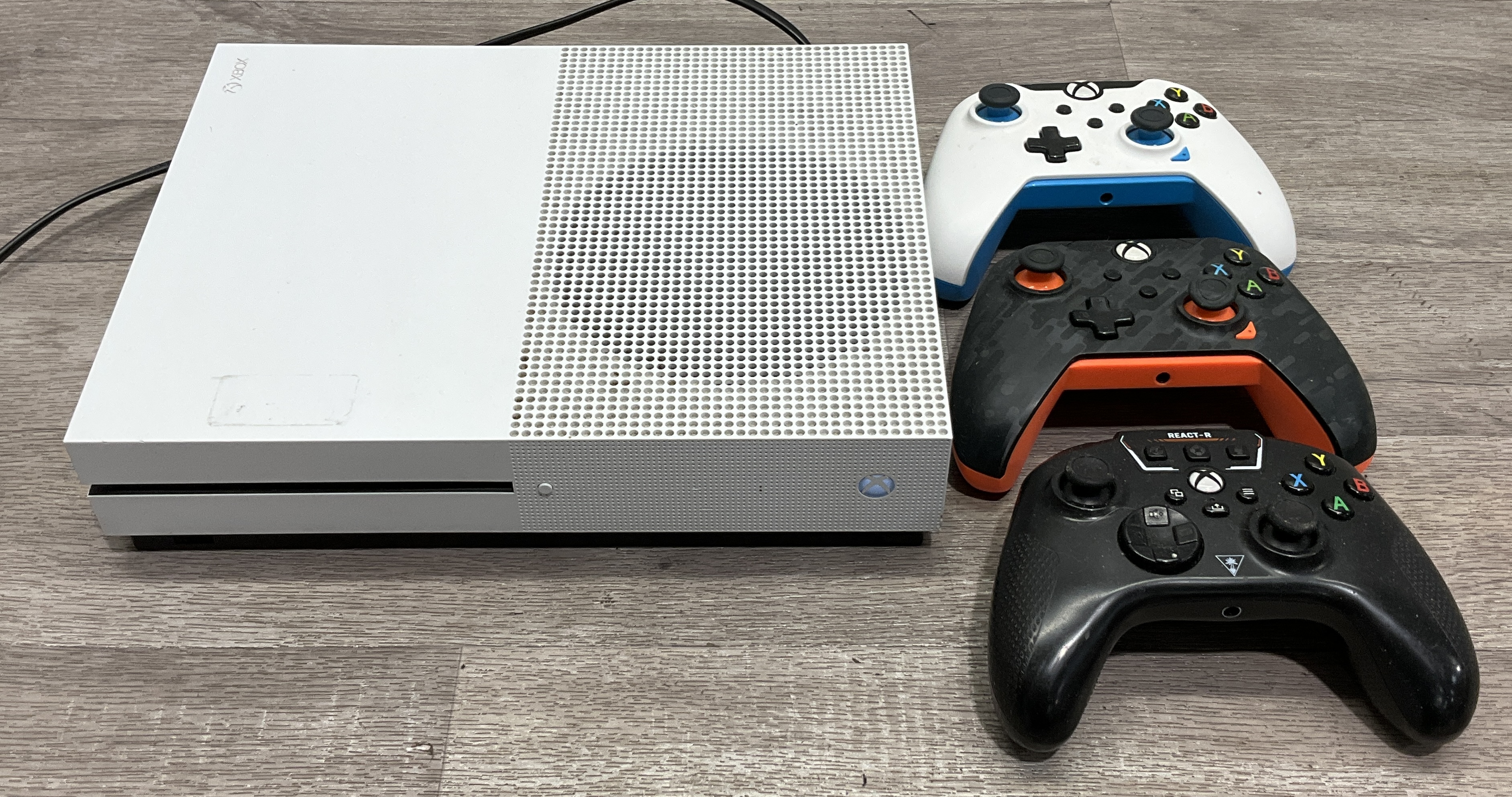 * A Microsoft Xbox One S Model 1681 Video Game Console and Three Third-Party Wired Controllers