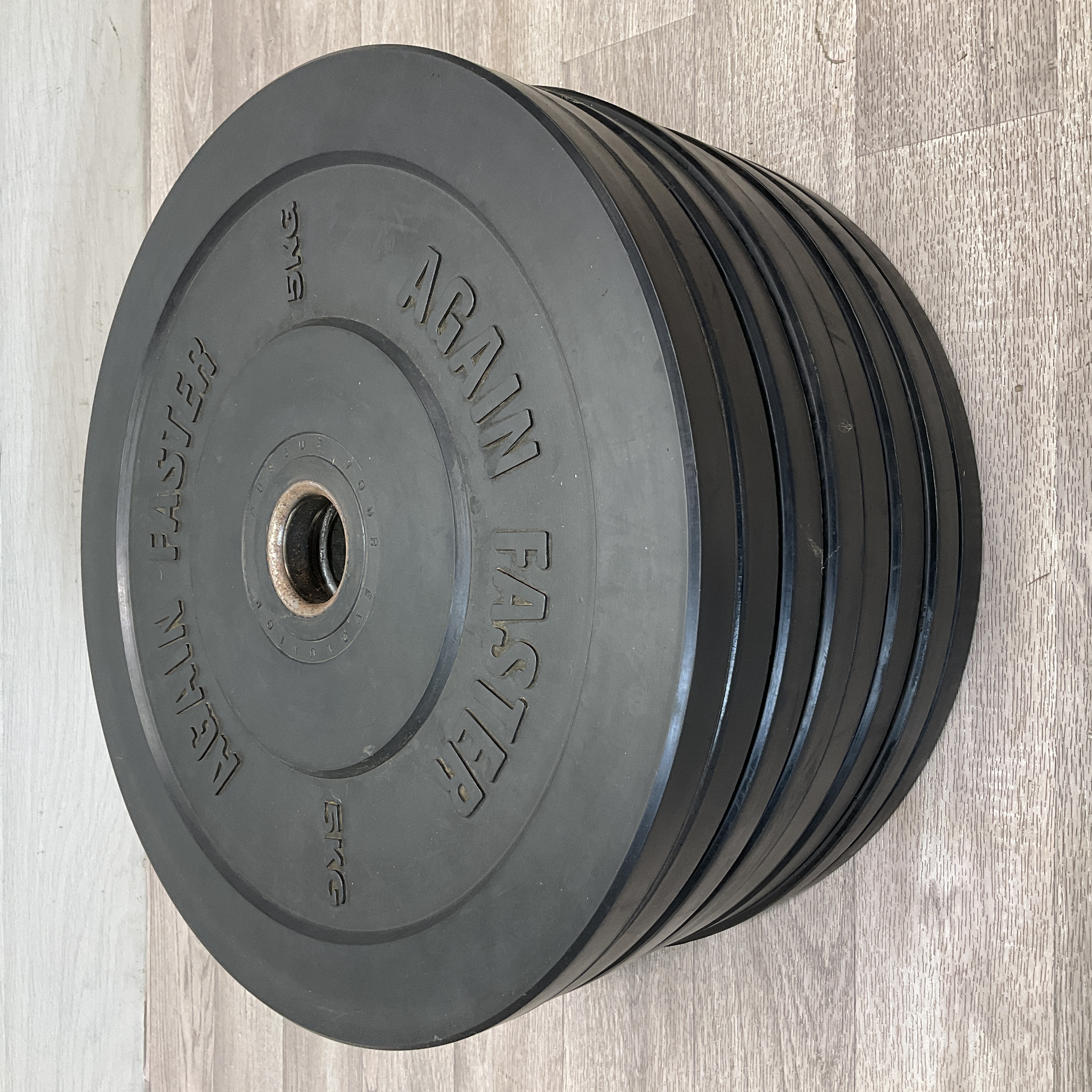 * A Set of Eight Again Faster 5kg Black Rubber Bumper Weight Plates