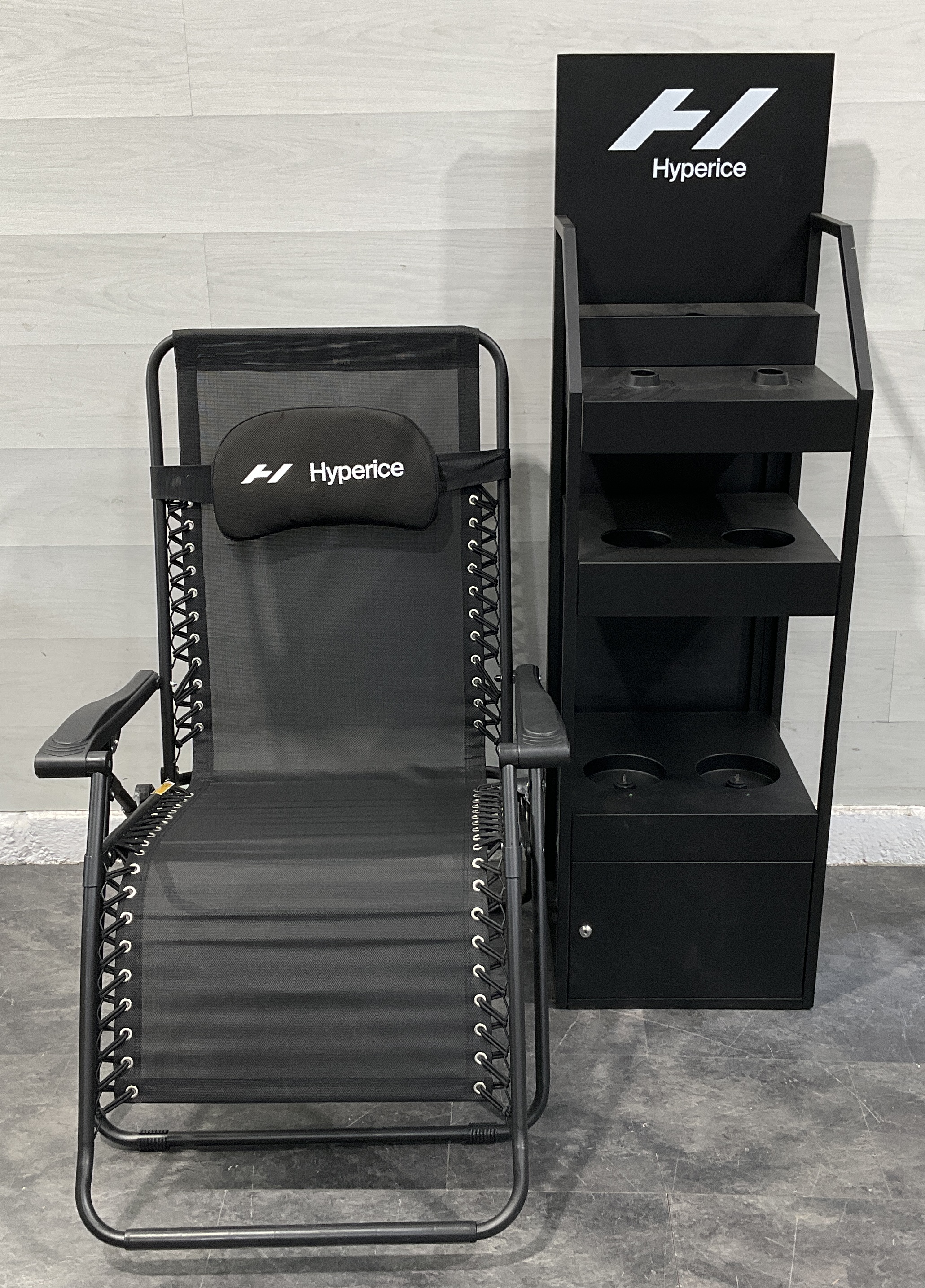 * Two Hyperice Branded Recovery Items: an HV2 Retail Display Charging Stand and a Zero-Gravity Chair