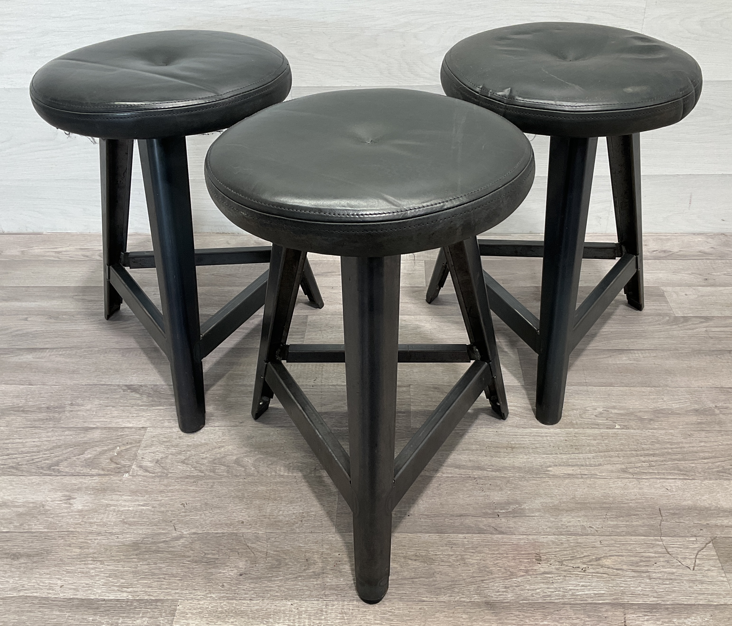 * A Set of Three Industrial Style Metal Framed Tripod Stools