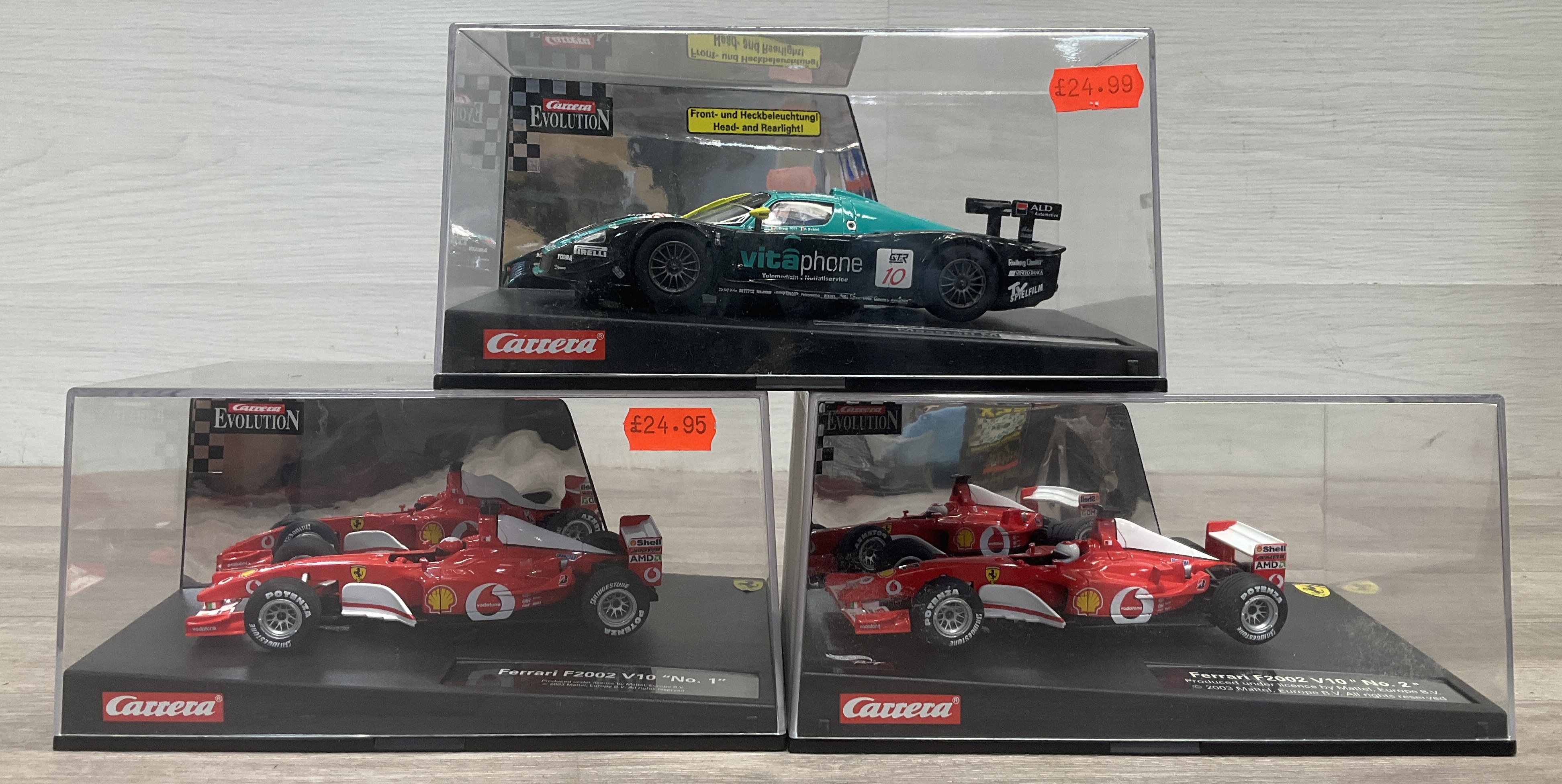 * A Carton Containing Three Carrera Evolution 1:32 Scale Slot Cars