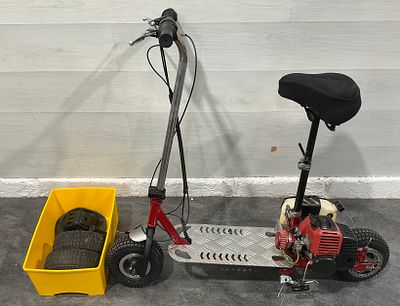 * A Petrol Powered Stand Up Scooter with Seat and Spares - REQUIRES ATTENTION. A petrol powered 