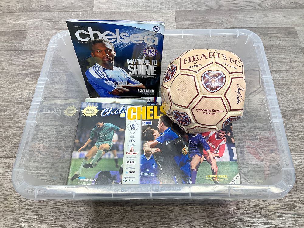 Lot 28: * A Crate Containing A Collection of Assorted Football Memorabilia including Chelsea FC Matchday Programmes and a Signed Heart of Midlothian FC Football