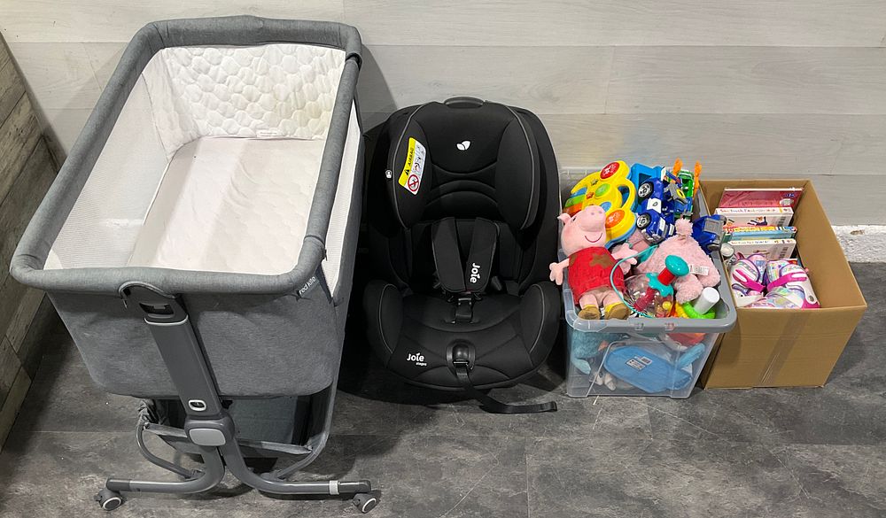 Lot 77: * A Red Kite Bedside Cribe, Joie Car Seat, A Carton and a Crate Containing An Assortment of Nursery Goods and Toys