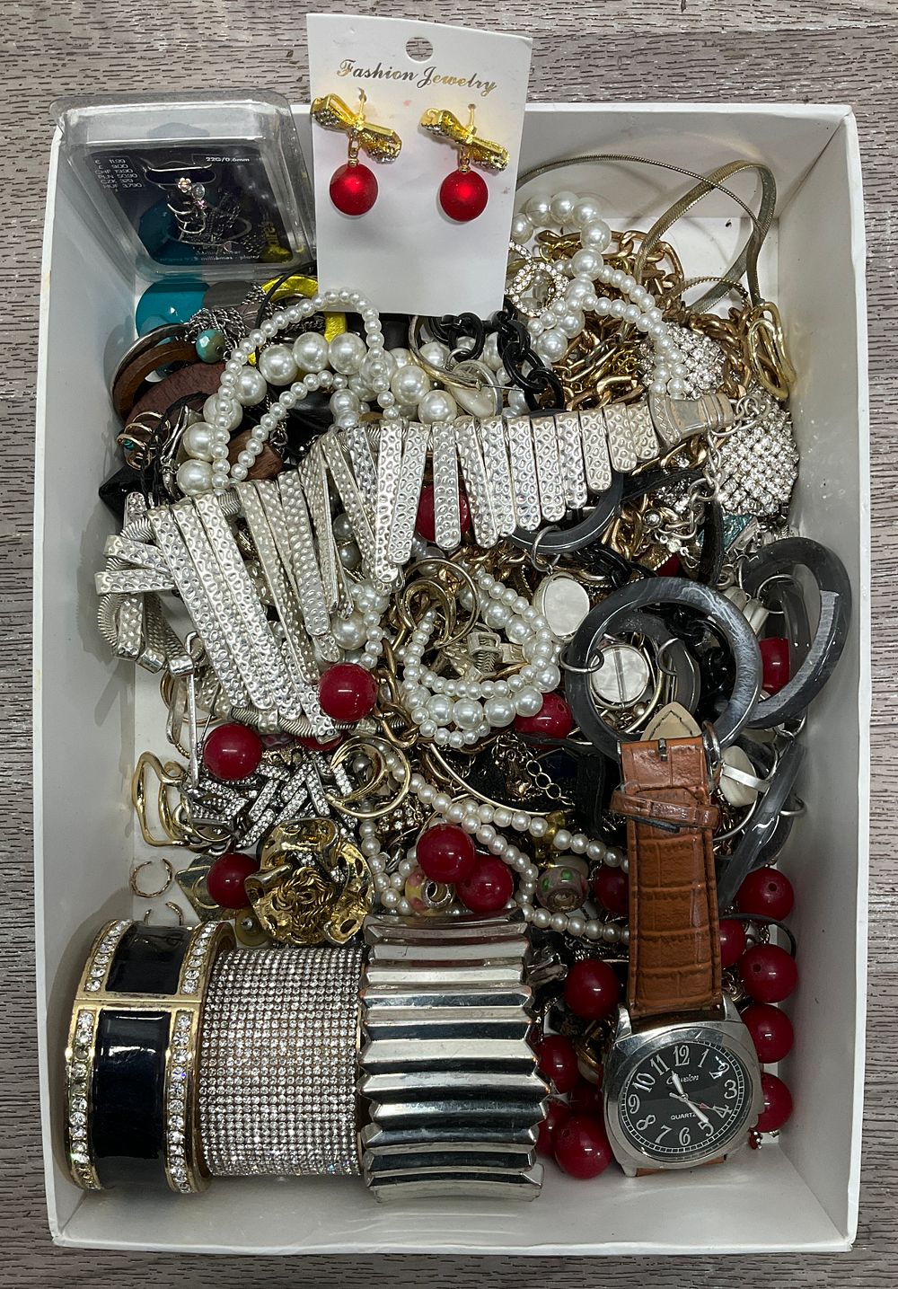 Lot 2: * A Carton Containing An Assortment of Costume Jewellery including a Cusion Wristwatch and Imitation Pearl Necklaces