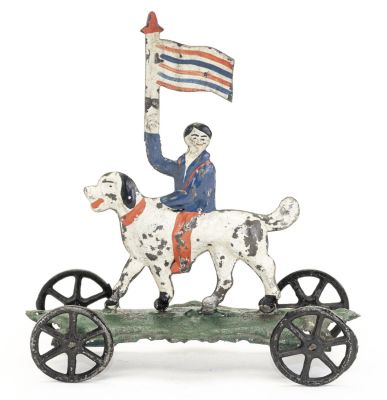 Boy Riding Dog Proudly Waving Flag, American Tin Toy. George Brown Company. Forestville, CT - 