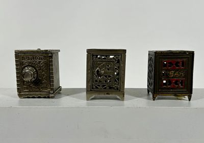 Three Cast Iron Safe Banks. American 1890/1900's - Each about 3 1/4"T Condition: Very Fine to 