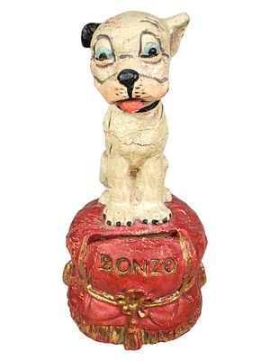 Smiling Bonzo on Red Pillow - A Rare Sawdust Composition Bank. By the Hausser Company for 