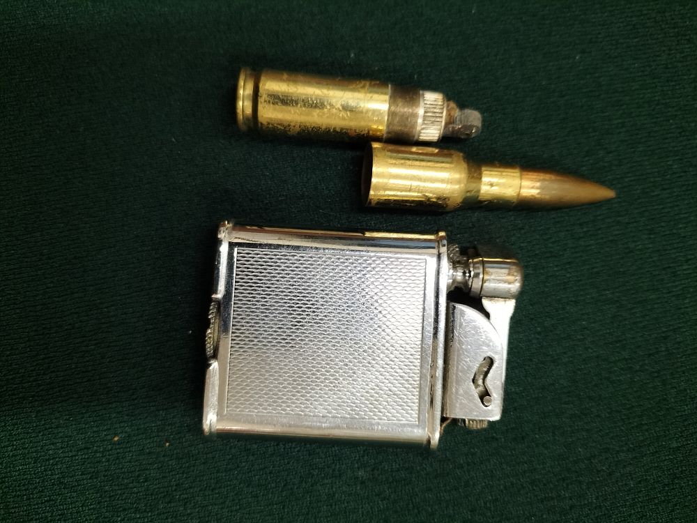 Lot 209 – Vintage Polo Lift-Arm Pocket Lighter and Brass Rifle Cartridge Novelty Lighter, circa 1930-1950