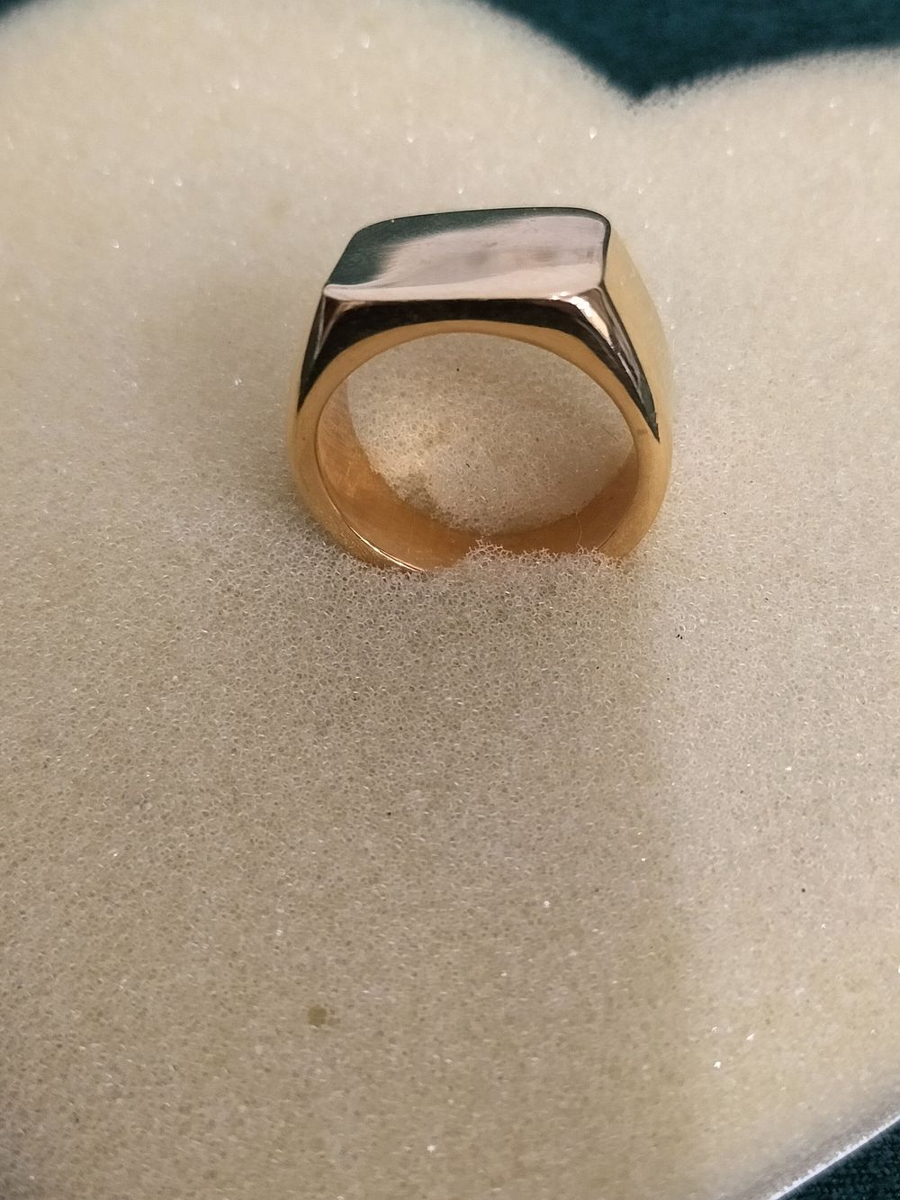 Lot 244 – A gold toned signet ring with a rectangular face