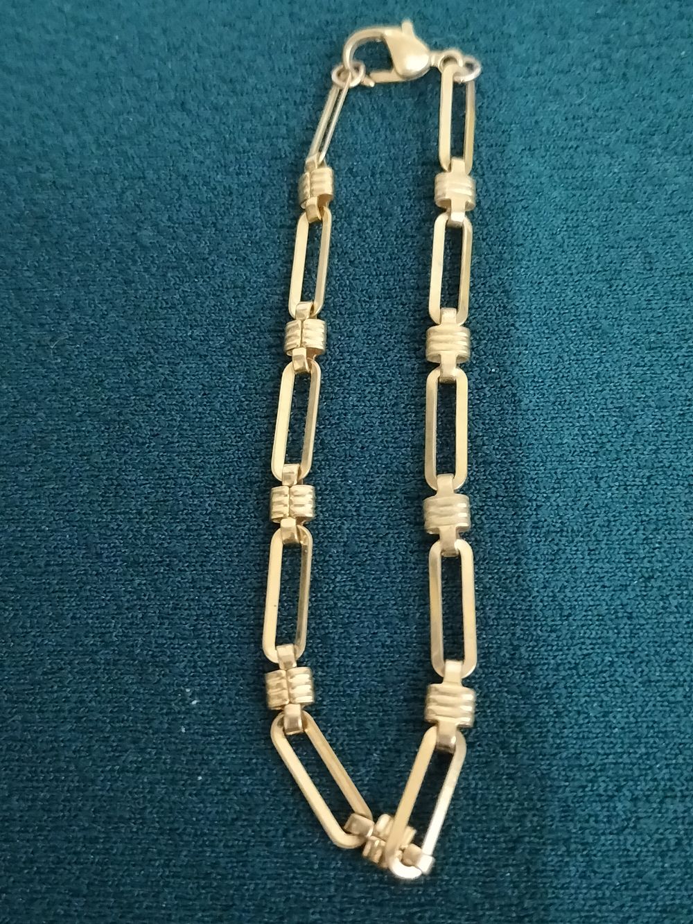 Lot 245 – Gold-tone paperclip link bracelet with ribbed connectors