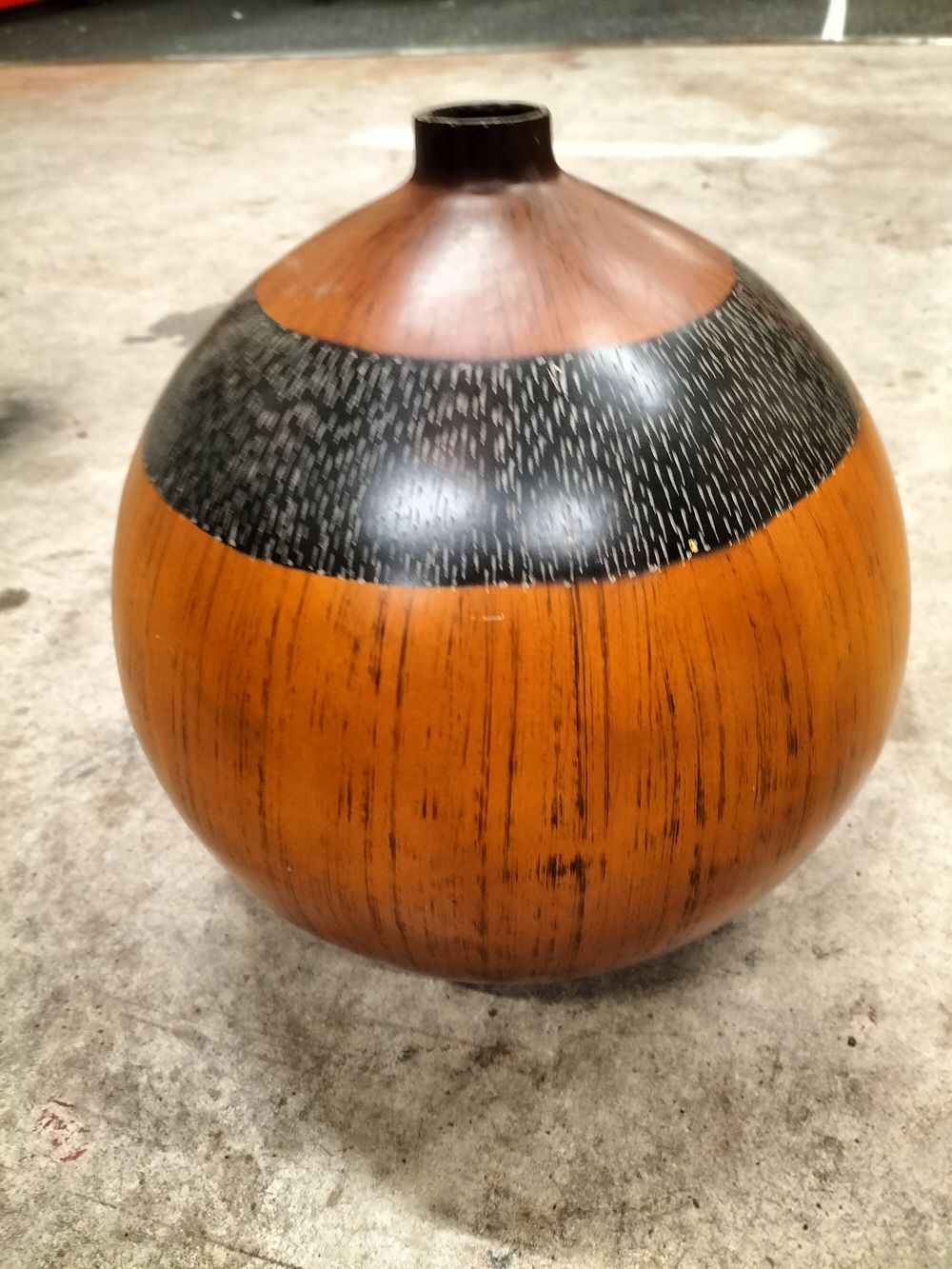 Lot 250 – A Spherical Wooden Vase with Textured Black Band